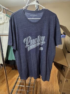 Lucky Brand Men's Heather Navy Graphic Tee with Light Blue Logo